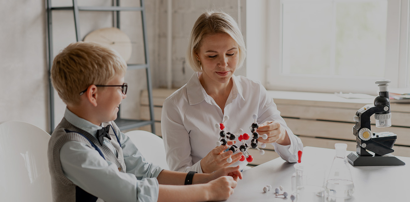 Female science tutor in Richmond studying chemistry with student